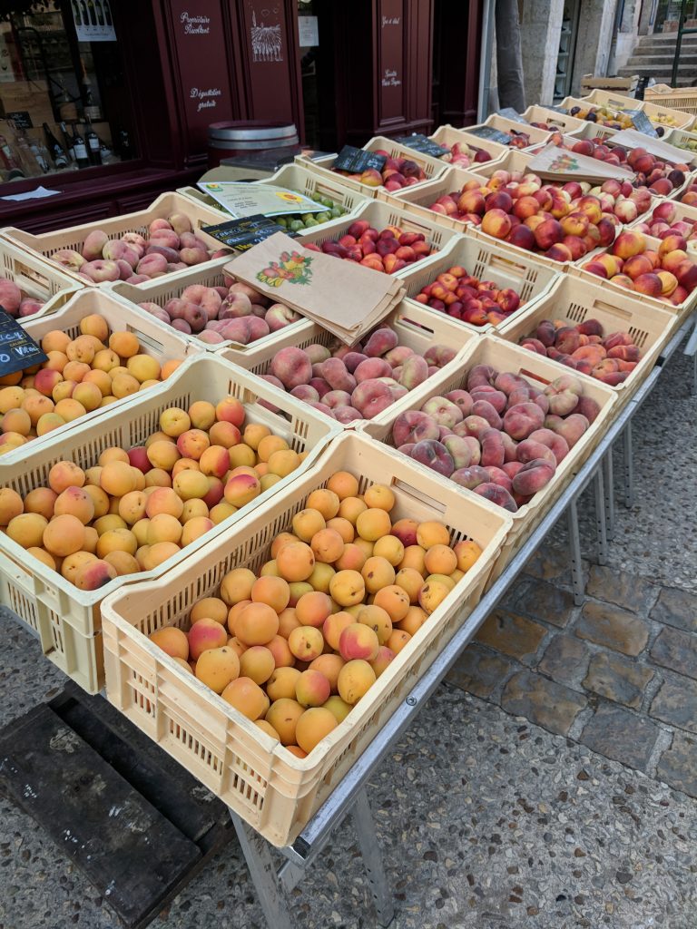 Fresh stone fruit on display at a French produce market