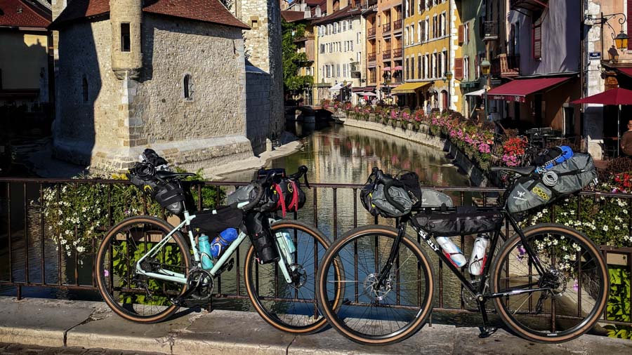 Two bikes resting against a rail in Annecy