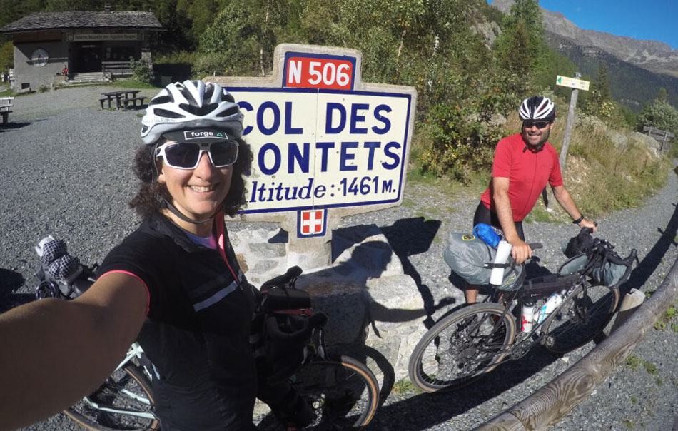 Two cyclists at the top of Col des Montets in the French Alps