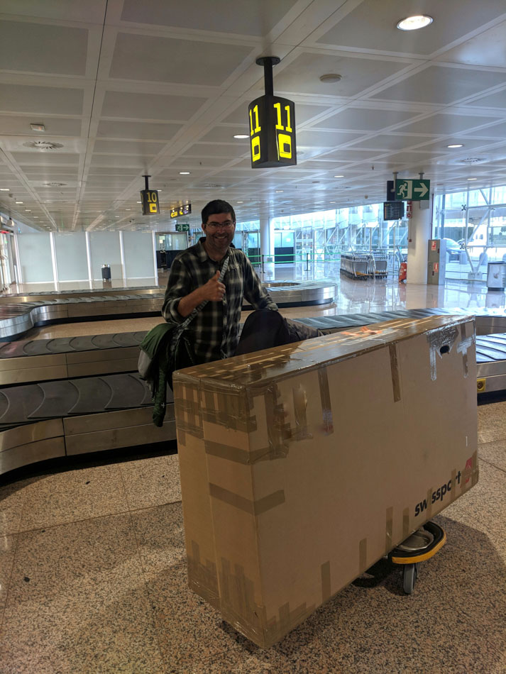 Wheeling cardboard bike boxes through the airport