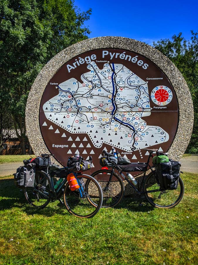 Two bikes in front of the Ariege Pyrenees sign
