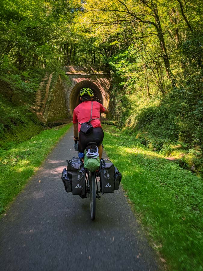 view of a cycle tourist about to enter a long rail tunnel on the Roger Lapébie Cycle Path
