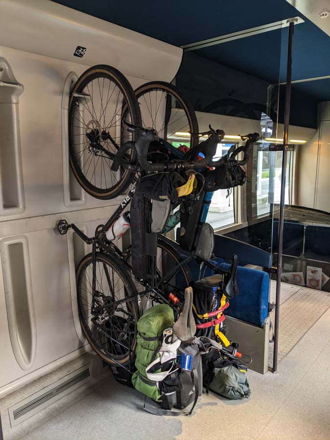 Two bikes hanging in the rack on a train in France