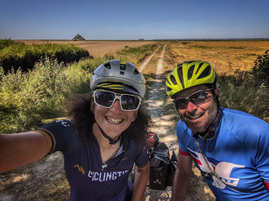 Two cyclists with Mont Saint Michel in the background