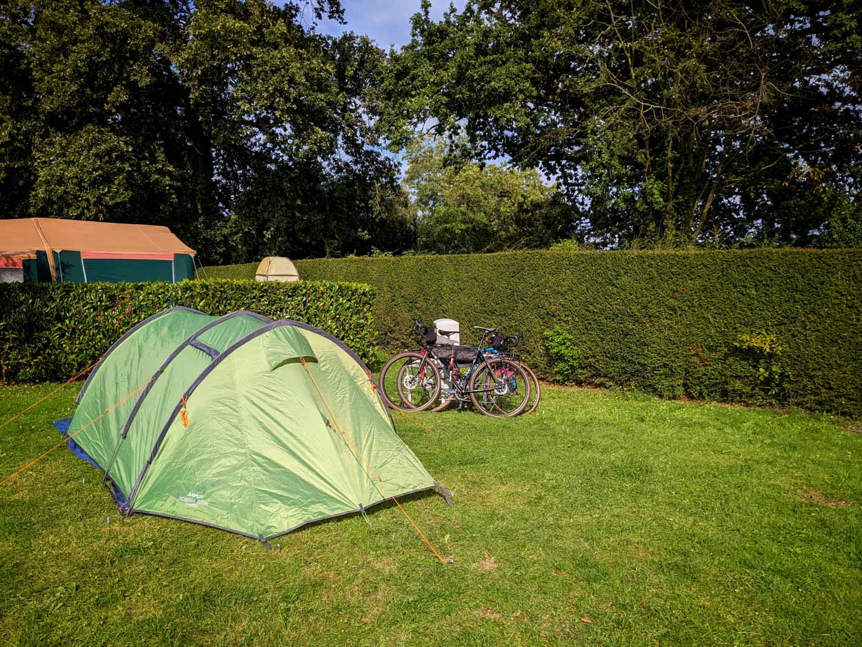 A campsite with tent and bikes