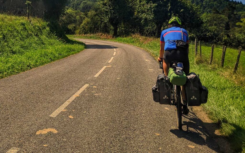 A cyclist on a small country road that is part of the V81 veloroute in France
