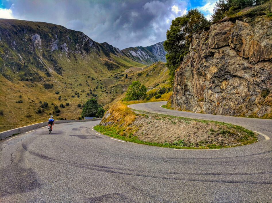 Cyclist descending Luz Ardiden switchbacks, French Pyrenees