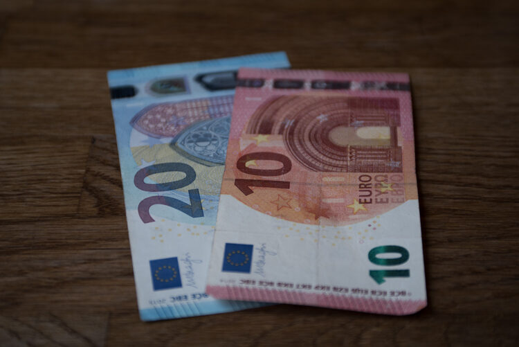 A 20 and 10 euro note sitting on a table in France