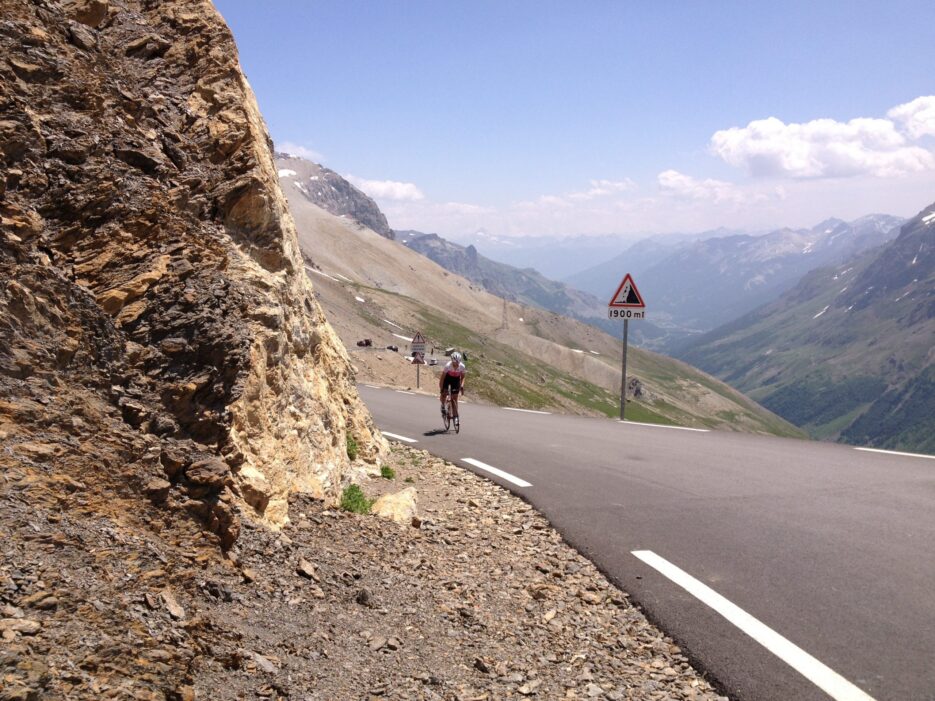 Cycling in the French Alps. A women cycling to the summit of Col du Galibier