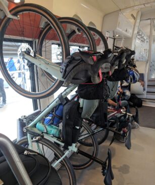 bicycles hanging from hooks in the storage area on french trains