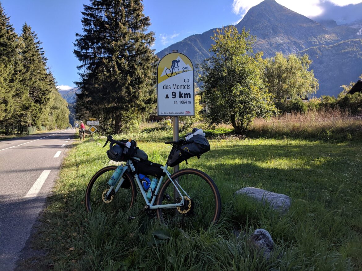 Bike leaning against an indicator sign for the Col des Montets