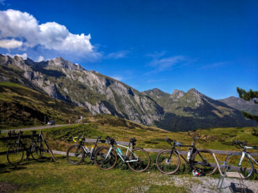 Bikes leaning against a fence at the top of Col du Soulor in the Pyrenees